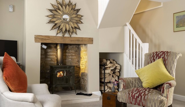 This charming Cotswold stone cottage, elegantly furnished with a seamless blend of antique and conte in Minchinhampton